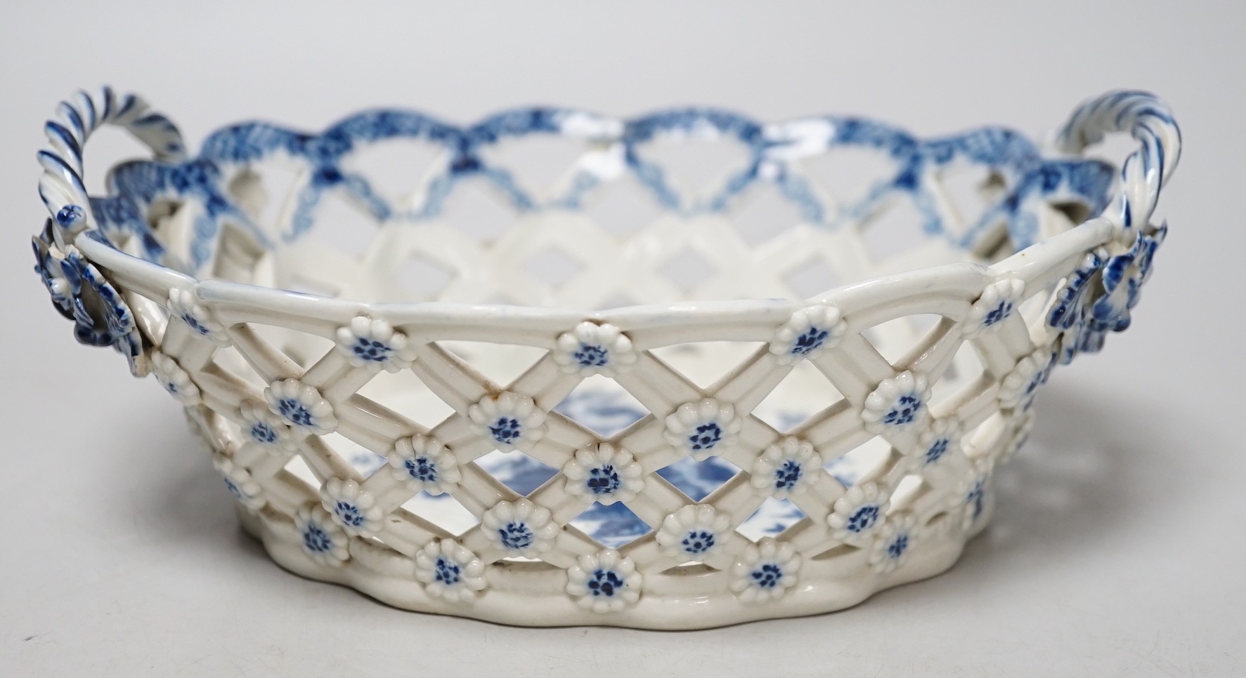 An 18th century Caughley basket printed with fir cones, under a painted border, C mark and very rare IT moulded mark, verso, Ex-Godden Reference Collection, 22cms wide